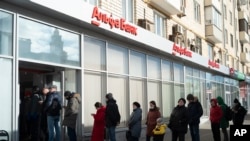 Orang-orang mengantre untuk menarik uang dari ATM Alfa Bank di Moskow, Rusia, 27 Februari 2022. 