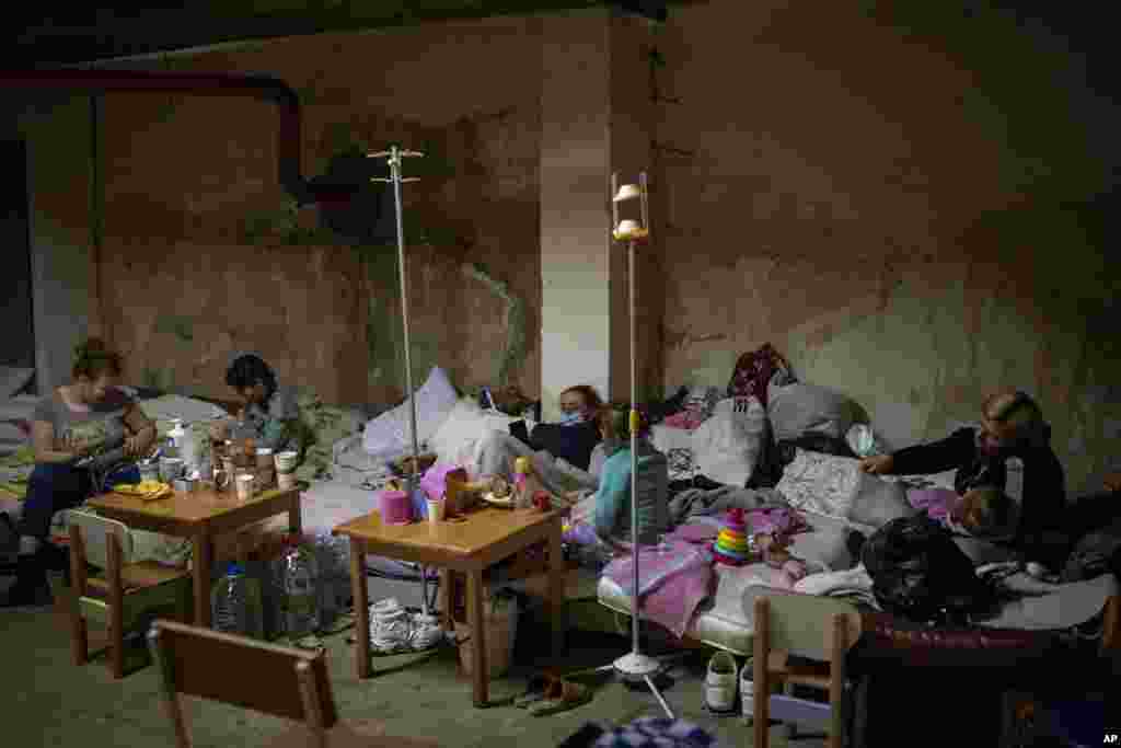 Sick children and women with their newborn babies shelter in a basement used as a bomb shelter at the Okhmadet children&#39;s hospital in central Kyiv, Ukraine.