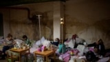 Sick children and women with their newborn babies stand at a basement used as a bomb shelter at the Okhmadet children's hospital in central Kyiv, Ukraine, March 1. 2022. 