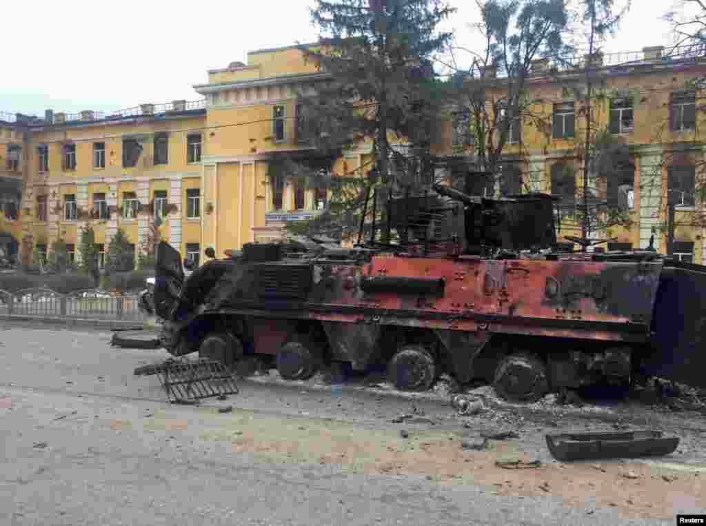 A destroyed armored vehicle is seen in front of a school which, according to local residents, was on fire after shelling, as Russia&#39;s invasion of Ukraine continues, in Kharkiv, Ukraine, Feb. 28, 2022.