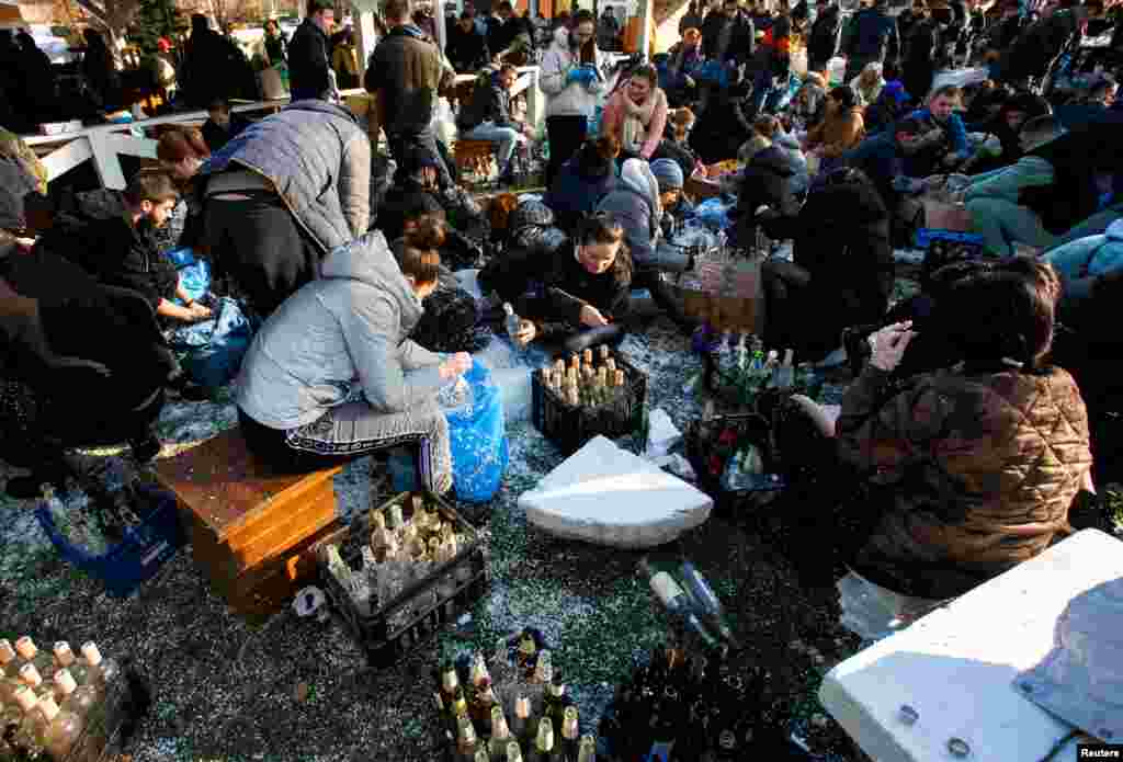 Local residents prepare Molotov cocktails to defend the city in Uzhhorod, Ukraine, after Russia launched a massive military operation against Ukraine, Feb. 27, 2022.