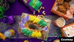 The king cake is commonly eaten in New Orleans during Carnival season. Purple, green, and gold are the colors of the season and often top the cake in the form of sugar. (Photo courtesy of The Big Book of King Cake.)