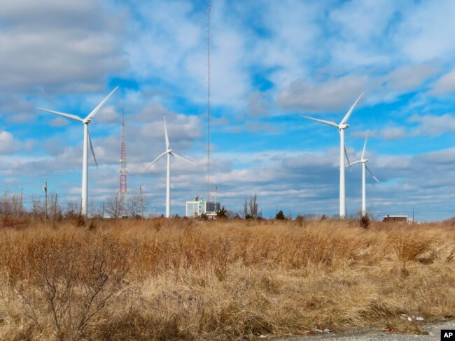 FILE - Land-based windmills in Atlantic City, N.J., help power a sewage treatment plant, taken Feb. 18, 2022. The new law includes $60 billion for clean energy manufacturing tax credit and $30 billion for a production tax credit for wind and solar. (AP Photo/Wayne Parry)