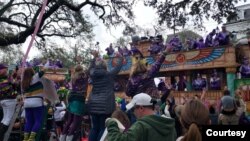 Paradegoers line New Orleans’ streets for miles hoping to catch trinkets from the Krewe of Thoth parade on Sunday afternoon.