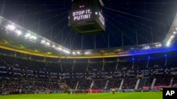 Teams pay a minute of silence for the people in Ukraine during a German Bundesliga soccer match between Eintracht Frankfurt and Bayern Munich in Frankfurt, Germany, Feb. 26, 2022. 