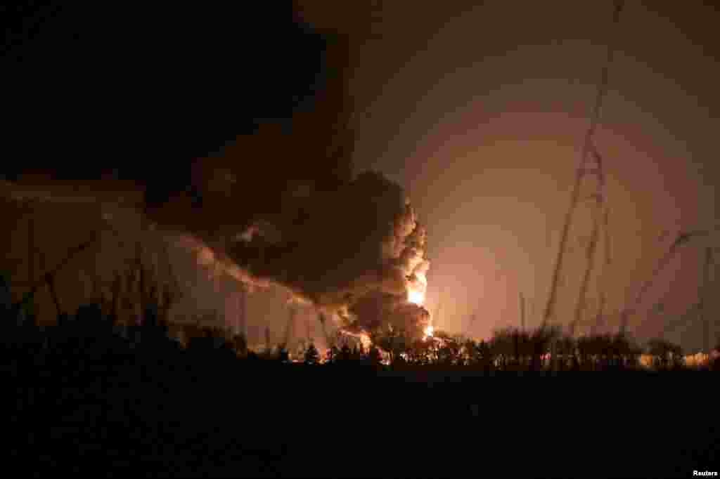 A view shows a burning oil depot reportedly hit by Russian shelling near the military airbase Vasylkiv in the Kyiv region, Ukraine, Feb. 27, 2022. 