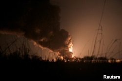 A view shows a burning oil depot reportedly hit by Russian shelling near the military airbase Vasylkiv in the Kyiv region, Ukraine, Feb. 27, 2022.