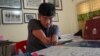 Artist Morn Chear carves a picture for his block-printing work in his studio, Siem Reap, February 12, 2022. (Khan Sokummono/VOA Khmer)