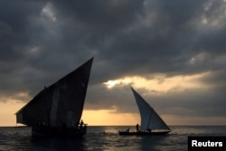 FILE - Fishermen throw an approach into the sea during sunset in Zanzibar's Stone Town on Oct. 26, 2005.