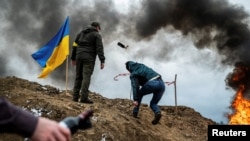 A civilian trains to throw Molotov cocktails to defend the city, as Russia's invasion of Ukraine continues, in Zhytomyr, Ukraine March 1, 2022. 