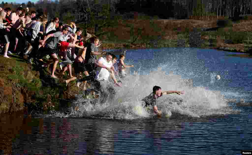 People from rival parishes of St. Michael and St. Paul compete in Scoring the Hales annual Shrove Tuesday Football match in Alnwick, Britain.