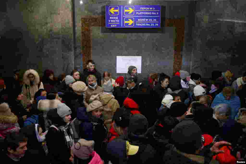 People fleeing stand in a crowded underpass at a train station to catch a train to Poland, in Lviv, Ukraine, Feb. 28, 2022.