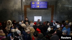 People fleeing stand in a crowded underpass at a train station to catch a train to Poland, in Lviv, Ukraine, Feb. 28, 2022. 