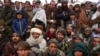 FILE - Hundreds of Afghan men gather to apply for humanitarian aid in Qala-e-Naw, Afghanistan, Dec. 14, 2021.