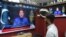 A man listens to Pakistan's Prime Minister Imran Khan addressing the nation on television at a market in Karachi, Feb. 28, 2022. 