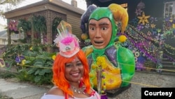 Tawanda Carter stands in front of a "House Float." She is in her dance krewe costume and dances in several parades each season.