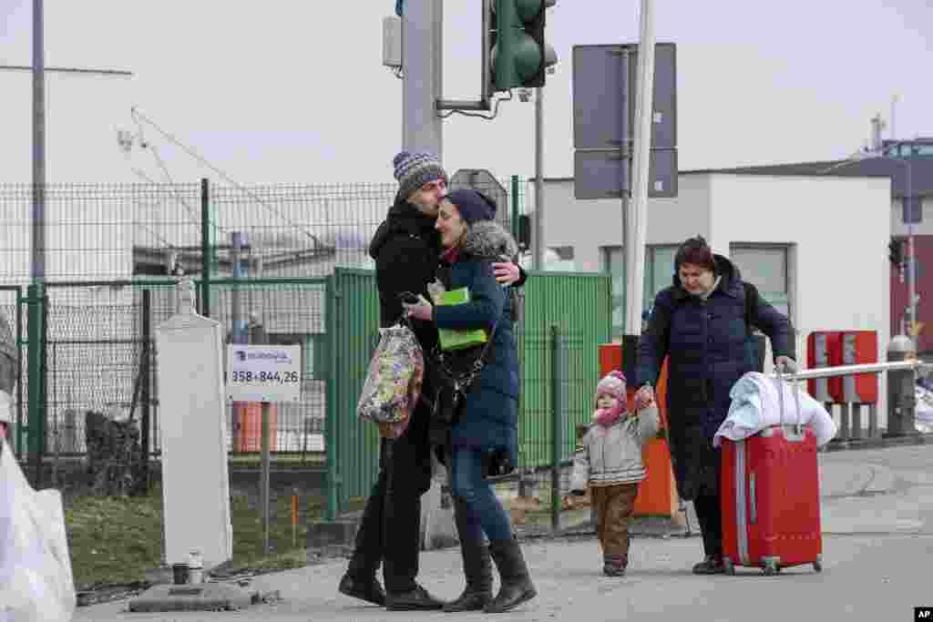 Family members hug as they reunite, after fleeing conflict in Ukraine, at the Medyka border crossing, in Poland, Feb. 27, 2022.