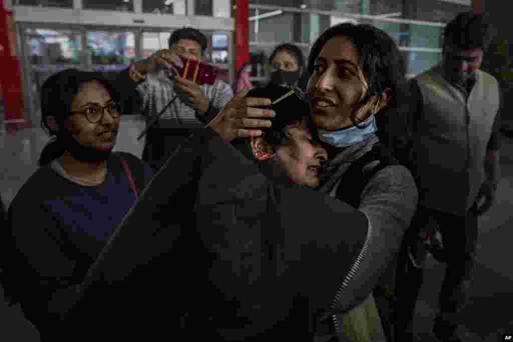 Mansi Singhal, an Indian student studying in Ukraine who fled the conflict, hugs her mother after she arriveds at Indira Gandhi International Airport in New Delhi, India, March 2, 2022.