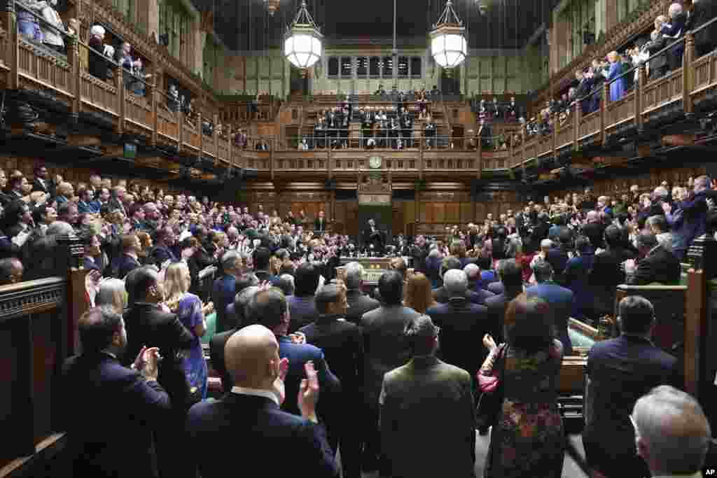 In this photo provided by UK Parliament, Ukraine&rsquo;s ambassador to the United Kingdom Vadym Prystaiko, upper right balcony, stands in the public gallery during applause from British lawmakers in the House of Commons, London.