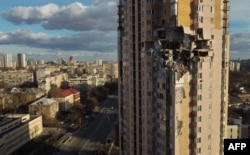 This general view shows damage to the upper floors of a building in Kyiv, Ukraine, Feb. 26, 2022, after it was reportedly struck by a Russian rocket.