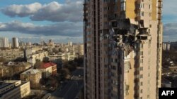 This general view shows damage to the upper floors of a building in Kyiv, Ukraine, Feb. 26, 2022, after it was reportedly struck by a Russian rocket.