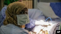 Doctors perform a repair surgery on a fistula patient who had previously undergone female genital mutilation, at the Edna Adan Maternity Hospital in Hargeisa, Somaliland, Feb. 8, 2022.