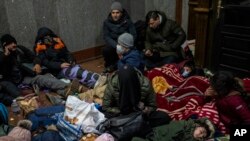 Afghans trying to flee Ukraine sleep inside Lviv railway station, Feb. 28, 2022, in Lviv, west Ukraine.