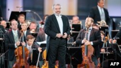 FILE - Russian conductor Valery Gergiev performs on stage with the Vienna Philharmonic Orchestra at Schoenbrunn Palace in Vienna, Austria, Sept. 18, 2020. 