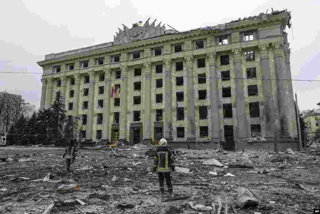 A member of the Ukrainian Emergency Service looks at the City Hall building in the central square following shelling in Kharkiv, March 1, 2022.&nbsp;&nbsp;Russian strikes pounded the central square in Ukraine&rsquo;s second-largest city and other civilian sites in what the country&rsquo;s president condemned as blatant campaign of terror by Moscow.