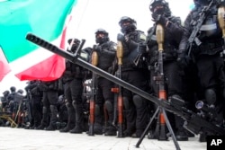 Servicemen gather to attend a review of the Chechen Republic's troops and military hardware in Grozny, the capital of the Chechen Republic, Russia, Feb. 25, 2022.