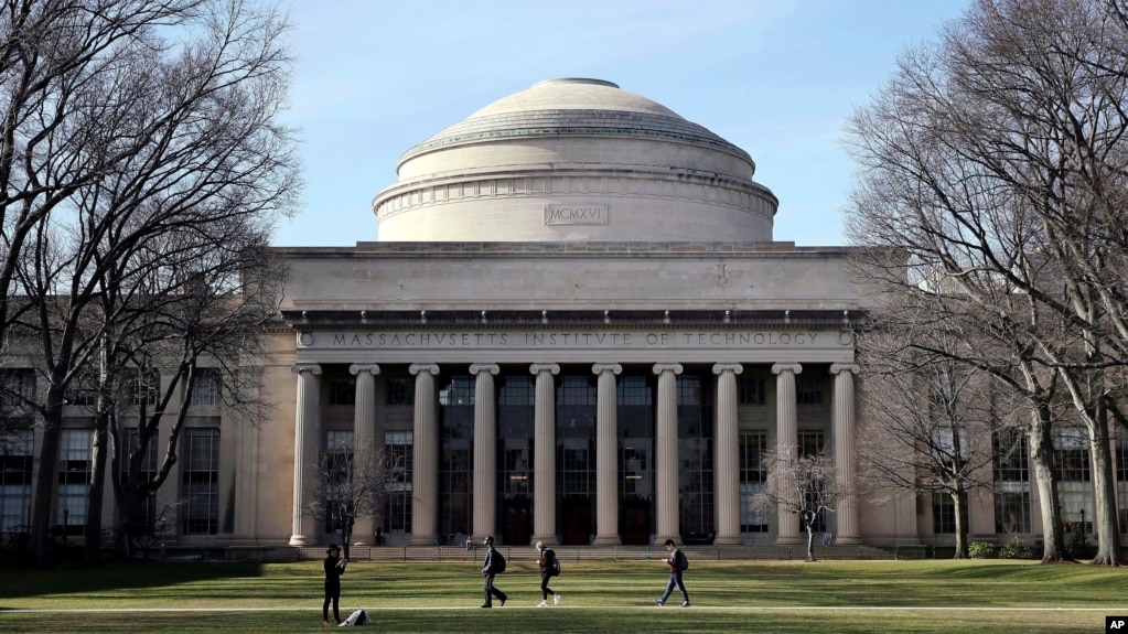 FILE - Students walk past the "Great Dome" atop Building 10 on the Massachusetts Institute of Technology campus, April 3, 2017, in Cambridge, Mass. (AP Photo/Charles Krupa, File)