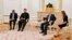 Russian President Vladimir Putin, center right, and Pakistan's Prime Minister Imran Khan, center left, talk during their meeting in Moscow, Feb. 24, 2022.