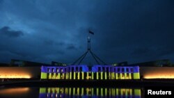 Australia’s Parliament House is seen illuminated with the colors of Ukraine's flag in solidarity with the country's people and government after Russia's invasion of Ukraine, in Canberra, Australia, Feb. 28, 2022.