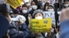 Activists hold placards as they gather near the Russian embassy to protest Russia's invasion of Ukraine, in Tokyo on Feb. 25, 2022.