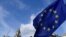An anti-Brexit placard and EU flag are held aloft outside of the Houses of Parliament, in London, Britain, March 18, 2019. 