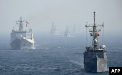 FILE - Chinese and other naval ships are seen in the Arabian Sea near Pakistan's port city of Karachi, Feb. 11, 2019.