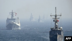 FILE - Chinese and other naval ships are seen in the Arabian Sea near Pakistan's port city of Karachi, Feb. 11, 2019. 