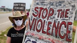 Protesters against the death penalty gather in Terre Haute, Ind., Wednesday, July 15, 2020. A U.S. judge has halted the execution of a federal death row inmate whose lawyers argue suffers from dementia. Wesley Ira Purkey was scheduled to be the…