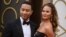 John Legend, left, and Christine Teigen arrive at the Oscars on March 2, 2014, at the Dolby Theatre in Los Angeles.