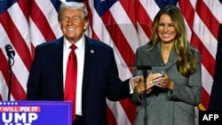 Former US President and Republican presidential candidate Donald Trump and former US First Lady Melania Trump smile after speaking during an election night event at the West Palm Beach Convention Center in West Palm Beach, Florida, early on November 6, 20