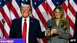 Former U.S. President and Republican presidential candidate Donald Trump and former First Lady Melania Trump smile after speaking during an election night event at the West Palm Beach Convention Center in West Palm Beach, Florida, early on Nov. 6, 2024.