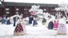 Visitors enjoy in snow at the Gyeongbok Palace, one of South Korea's well-known landmarks, in Seoul, South Korea, Nov. 27, 2024.