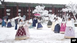 Visitors enjoy in snow at the Gyeongbok Palace, one of South Korea's well-known landmarks, in Seoul, South Korea, Nov. 27, 2024.