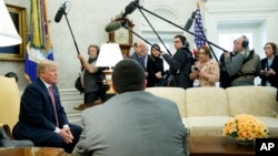 President Donald Trump speaks to reporters in the Oval Office of the White House, Feb. 9, 2018, in Washington. 