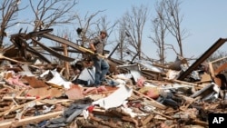 Zach Champion walks through the rubble of his mobile home looking for his belongings, in the Steelman Estates Mobile Home Park, destroyed in Sunday's tornado, near Shawnee, Oklahoma, May 20, 2013.