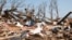 Zach Champion walks through the rubble of his mobile home looking for his belongings, in the Steelman Estates Mobile Home Park, destroyed in Sunday's tornado, near Shawnee, Oklahoma, May 20, 2013.