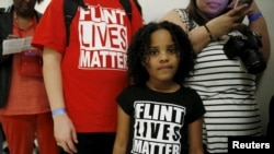 FILE - Mari Copeny, 8, of Flint, Michigan, waits in line to enter a hearing room where Michigan Governor Rick Snyder (R) and EPA Administrator Gina McCarthy will testify before a House Oversight and government Reform hearing on Capitol Hill in Washington