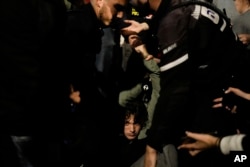 FILE—Police detain a demonstrator during a protest against Israeli Prime Minister Benjamin Netanyahu's government in Tel Aviv, Israel, March 2, 2024.