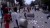 Protesters throw trash on street during a demonstration against President Jovenel Moise in Gonaïves, Haiti, June 14, 2019. 