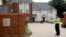 British police officers stand outside a residential property in Amesbury, England, July 4, 2018. British police have declared a "major incident" after two people were exposed to an unknown substance in the town.